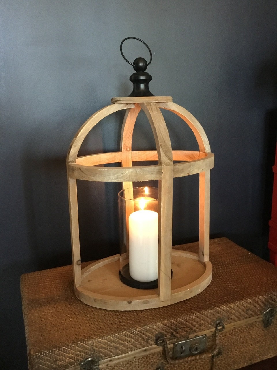 Wooden Oval Lantern of solid, reclaimed wood, banded straps, hurricane glass and metal handle.