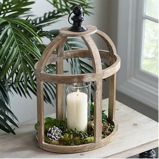 Wooden Oval Lantern of solid, reclaimed wood, banded straps, hurricane glass and metal handle.